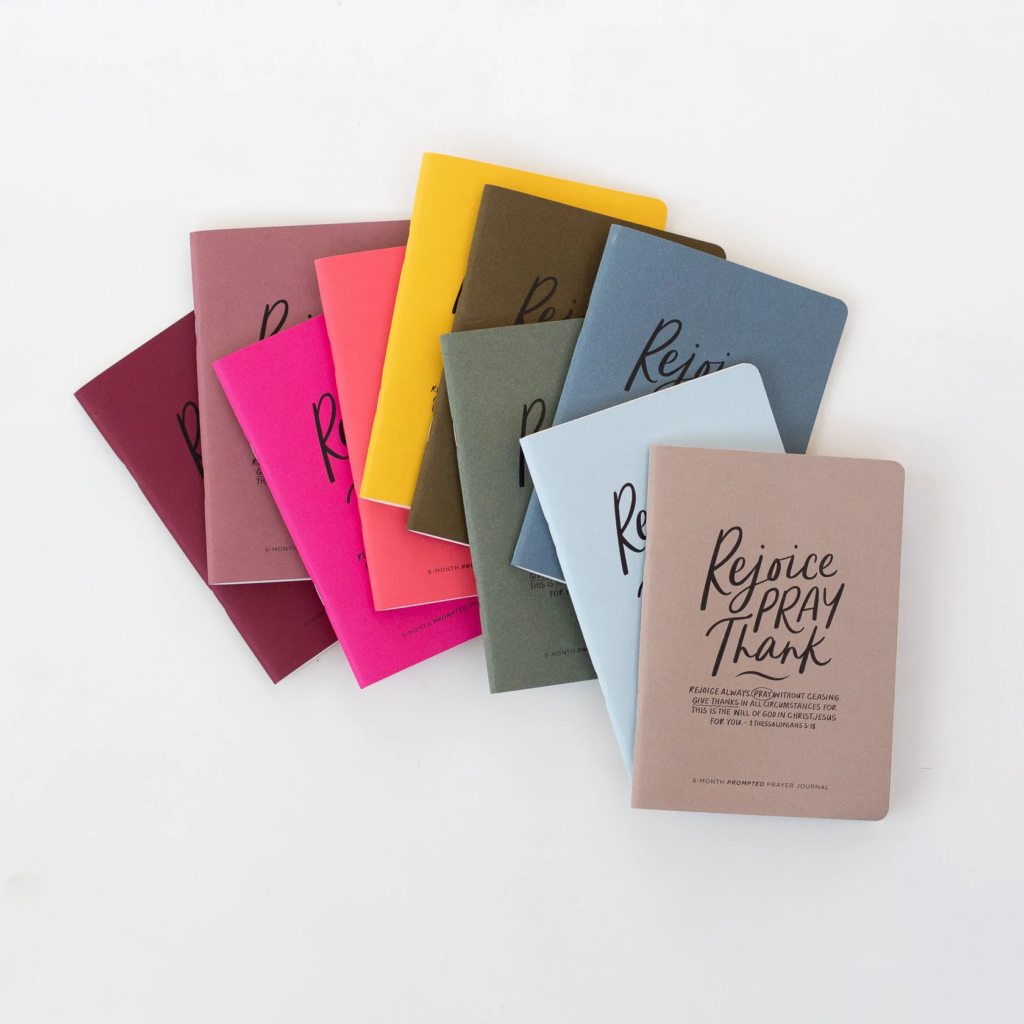 colorful journals with a cover that says rejoice, pray, thank