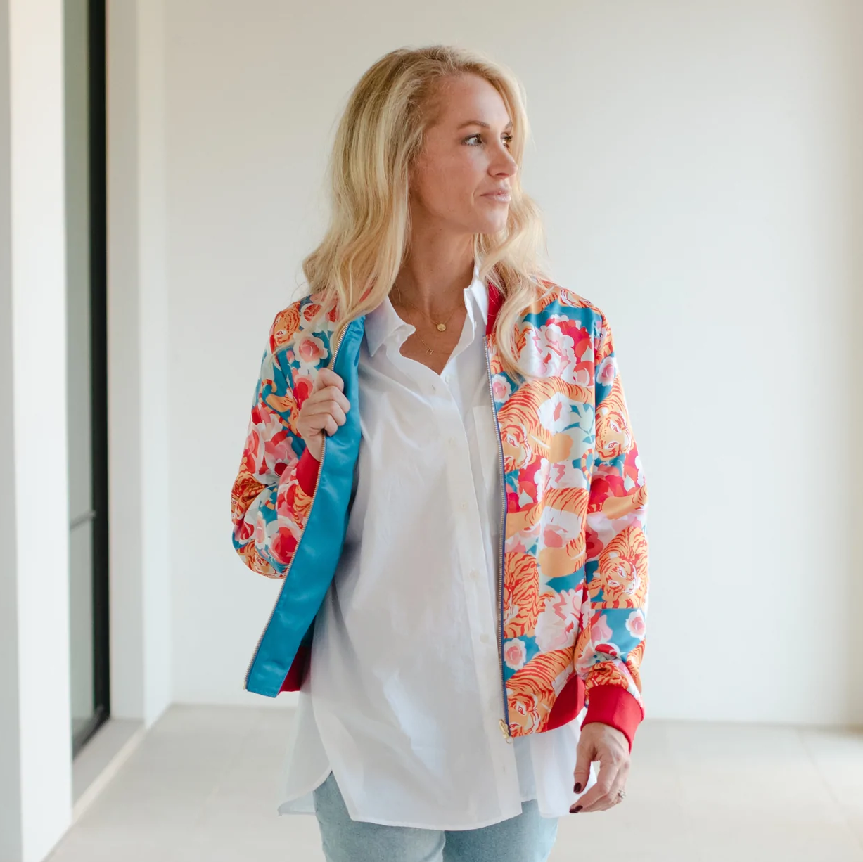 woman with floral print bomber jacket