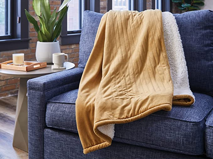 yellow fleece lined blanket on blue couch