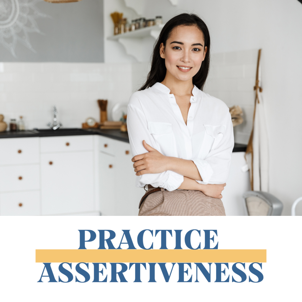 Smiling woman standing with crossed arms. Practice assertiveness.
